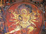 Tibet Guge 08 Tsaparang 04 Yamantaka Temple Chakrasamvara On the right wall is a four-headed, 12-armed large painting of Chakrasamvara (Tib. Demchog), embracing his consort Vajravarahi. Vajravarahis left hand circles Chakrasamvaras neck while her right holds a vajra. In his right hands he holds a vajra lasso, a drum, a hatchet, a chopper and a trident; while his left hands hold the vajra lasso, a skull full of blood, a noose and the heads of Brahma. Photo - Weyer/Aschoff: Tsaparang, Tibets Grosses Geheimnis.